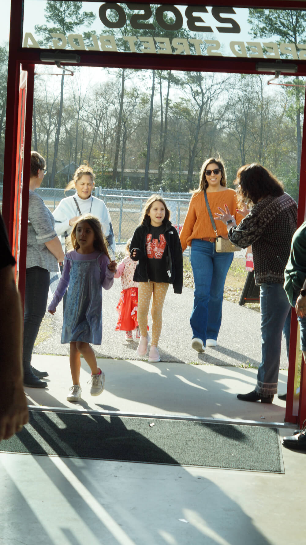 family walking through doors of church and being greeted